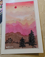 Postcard of layered pink mountains at sunset with pine silhouettes and birds